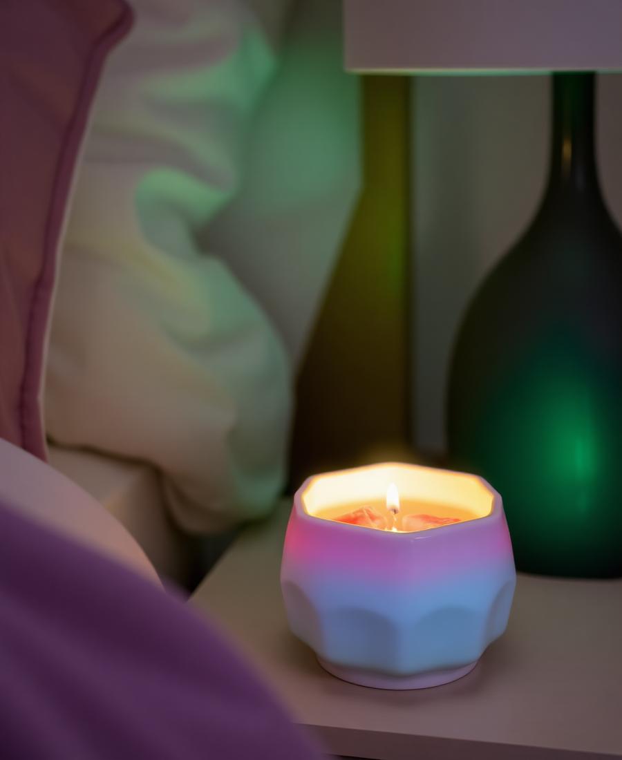 Colourful wax melts melting in a glowing wax warmer